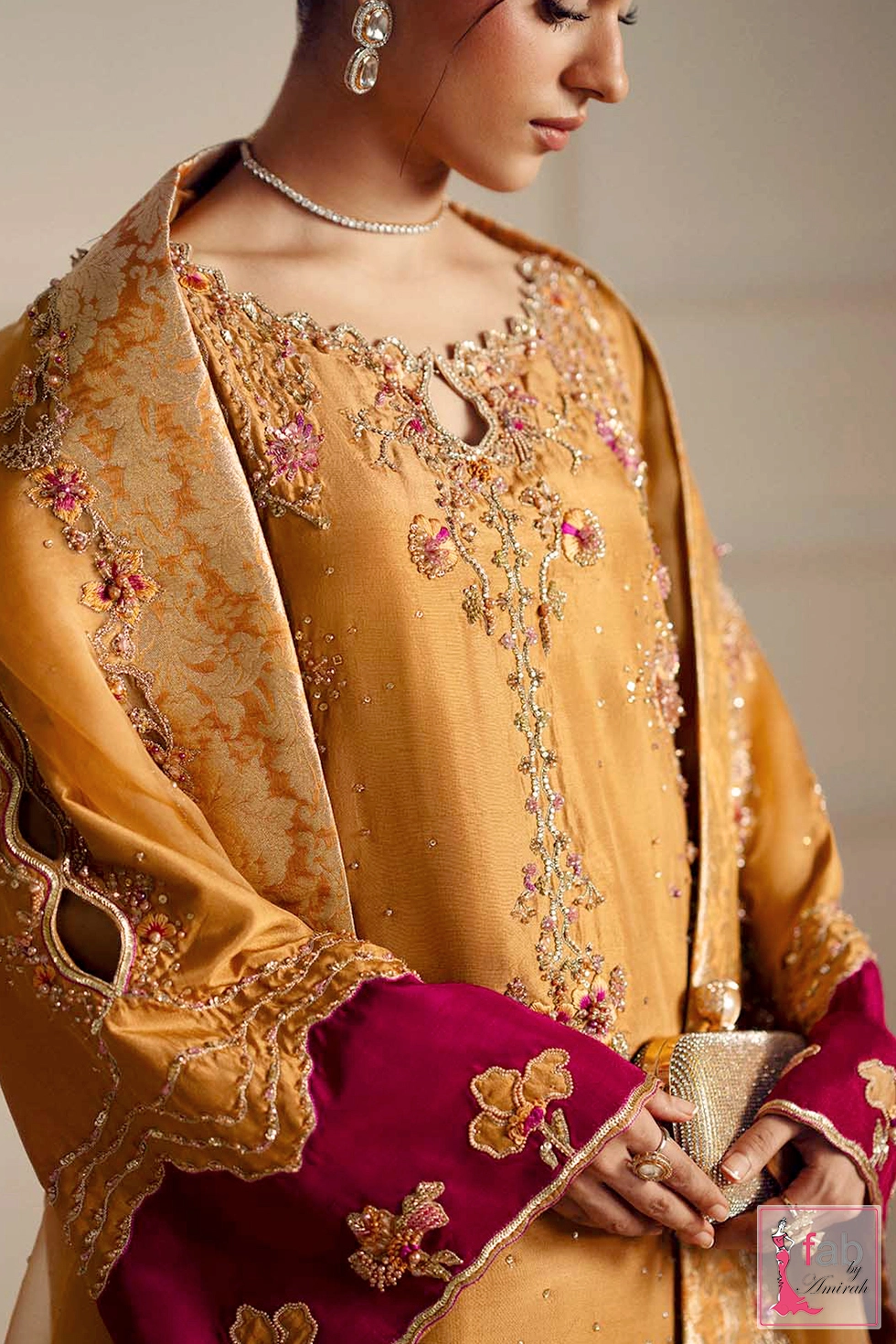 Detailed view of bell sleeve embroidery with magenta contrast cuff