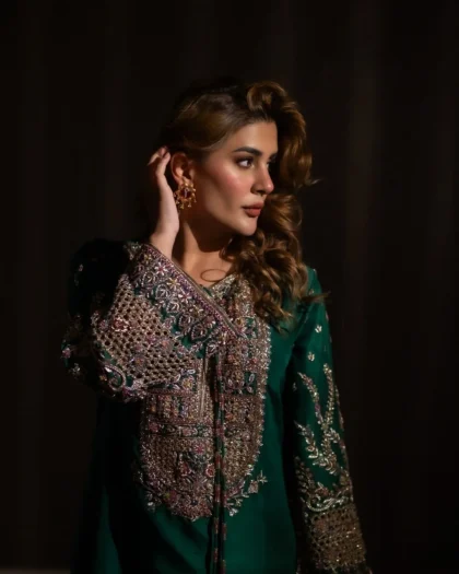 Side profile view highlighting detailed neck embroidery and sleeve drape