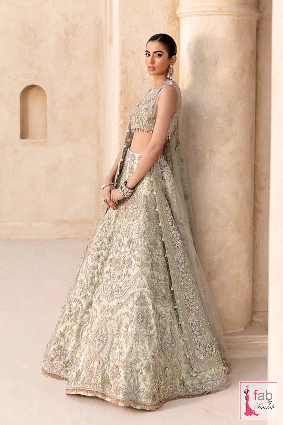 Side profile of mint green lehenga skirt showing sweeping panel details and net dupatta