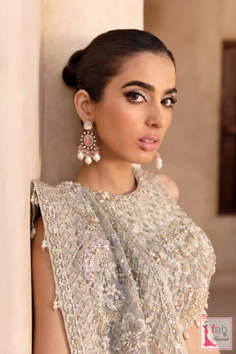 Detailed shot of high neckline and pearl drop earings with mint green lehenga