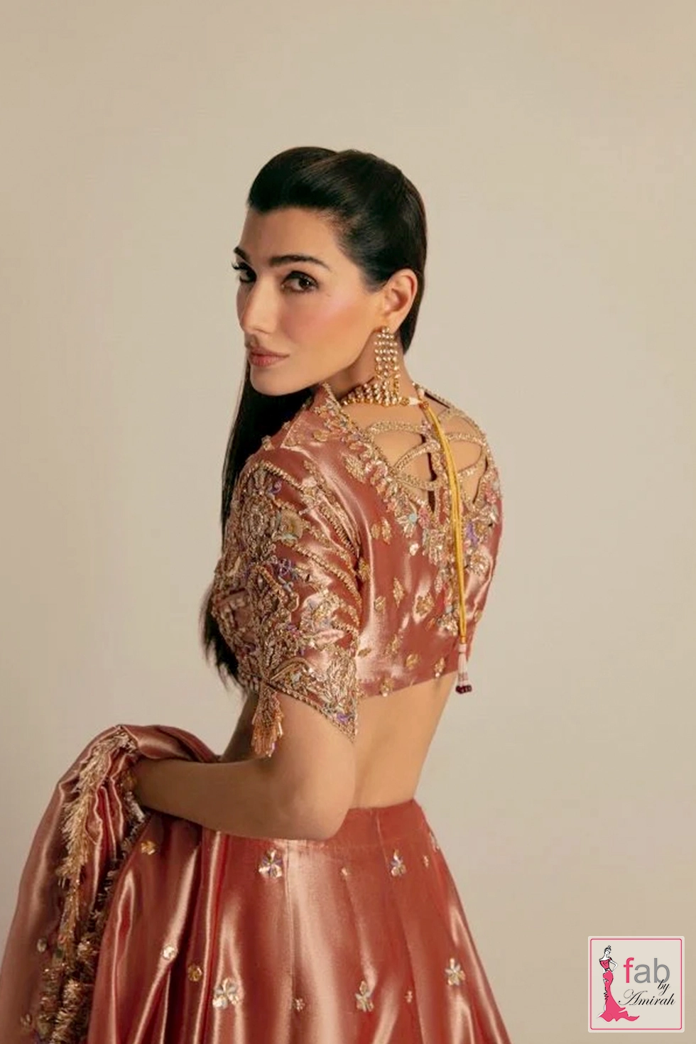 Detailed back view of hand embroidered choli neck ties and lattice work