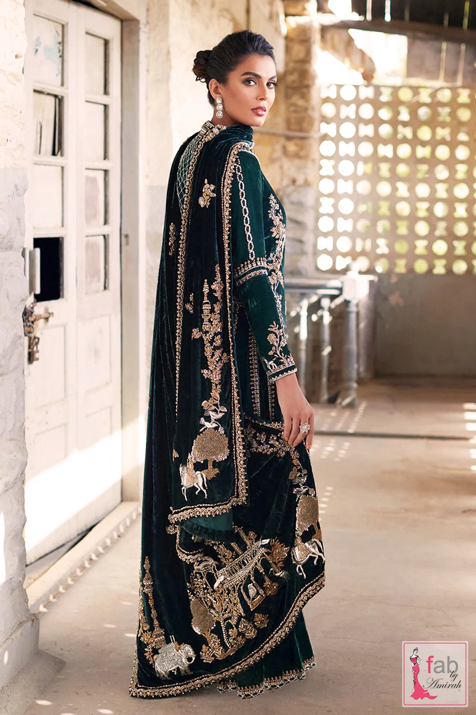 Close-up of Mughal inspired gold and silver embroidery on dark green velvet jacket
