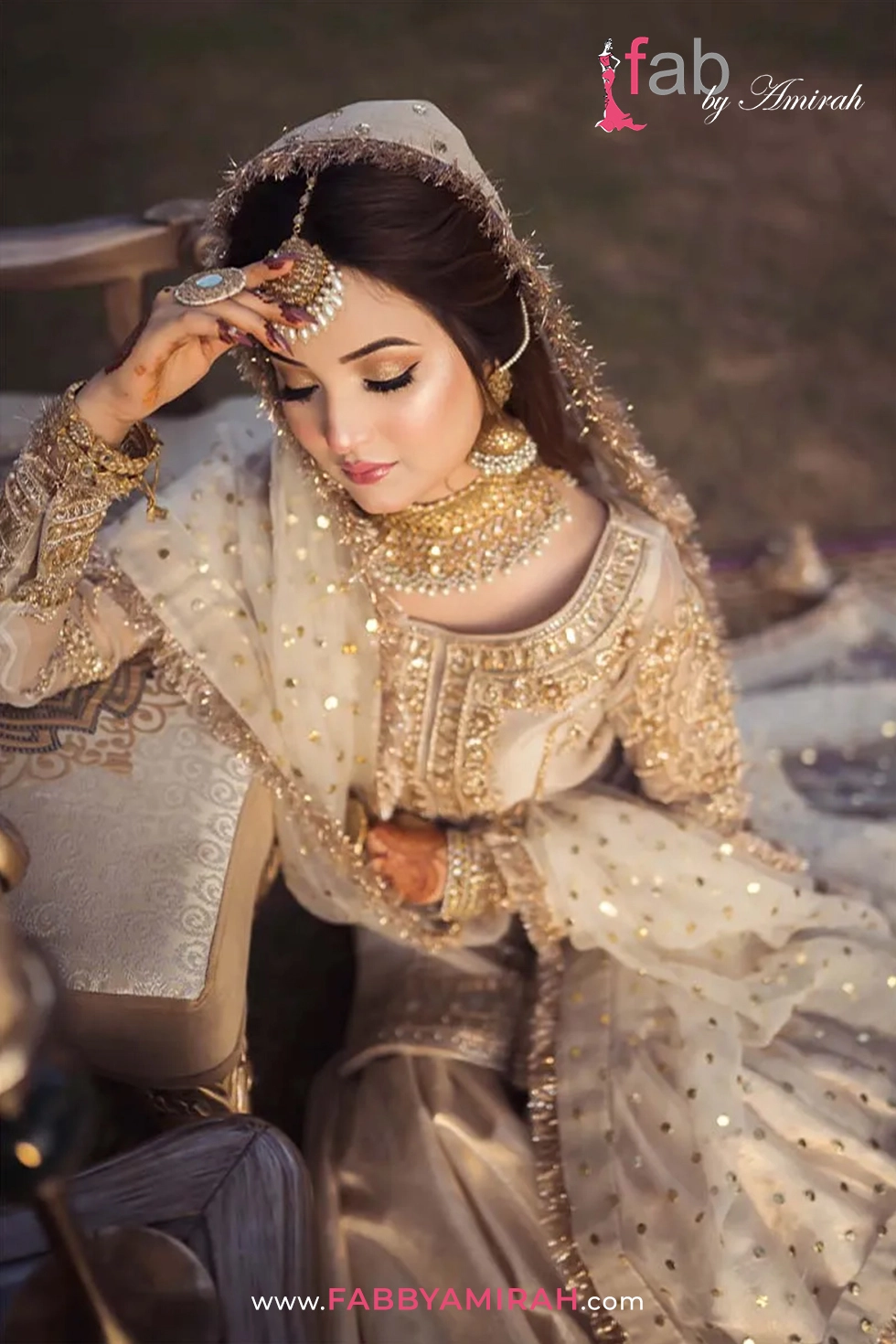 Close-up of antique gold tilla embroidery on off white organza