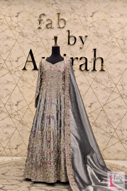 Grey tissue bridal maxi gown with intricate silver hand embroidery on display