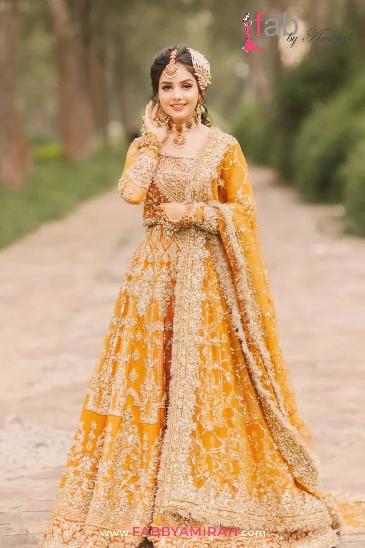 Luxury bridal lehnga in orange and gold organza with heavy Resham work by Fab By Amirah