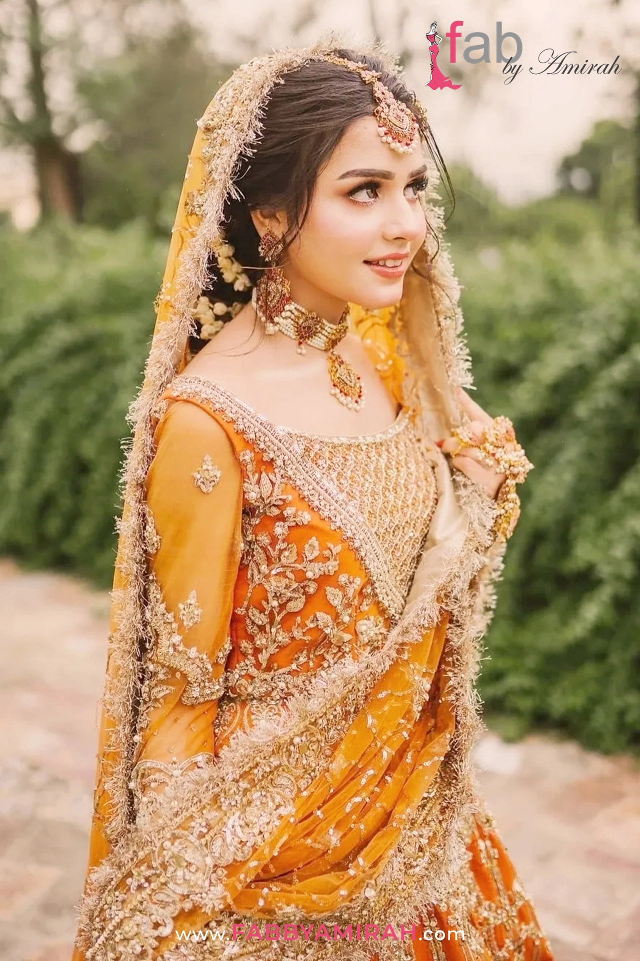 Side view of sunset orange kurti and flared luxury bridal lehnga with tilla work