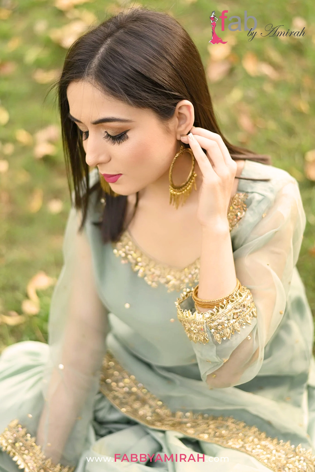 Close-up of intricate sequins and stone spray on light ferozi organza sharara set Close-up of intricate sequins and stone spray on light ferozi organza sharara set