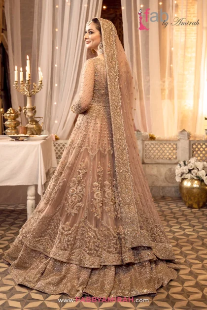 Back view of peach pink pishwas showing detailed traditional embellishment pattern
