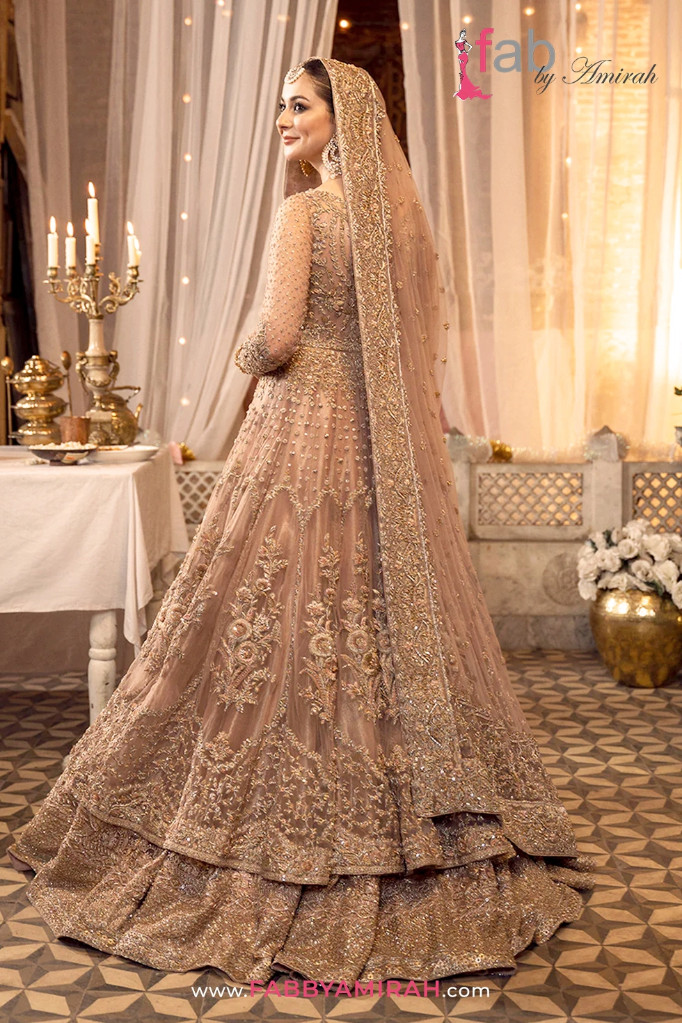 Back view of peach pink pishwas showing detailed traditional embellishment pattern Back view of peach pink pishwas showing detailed traditional embellishment pattern
