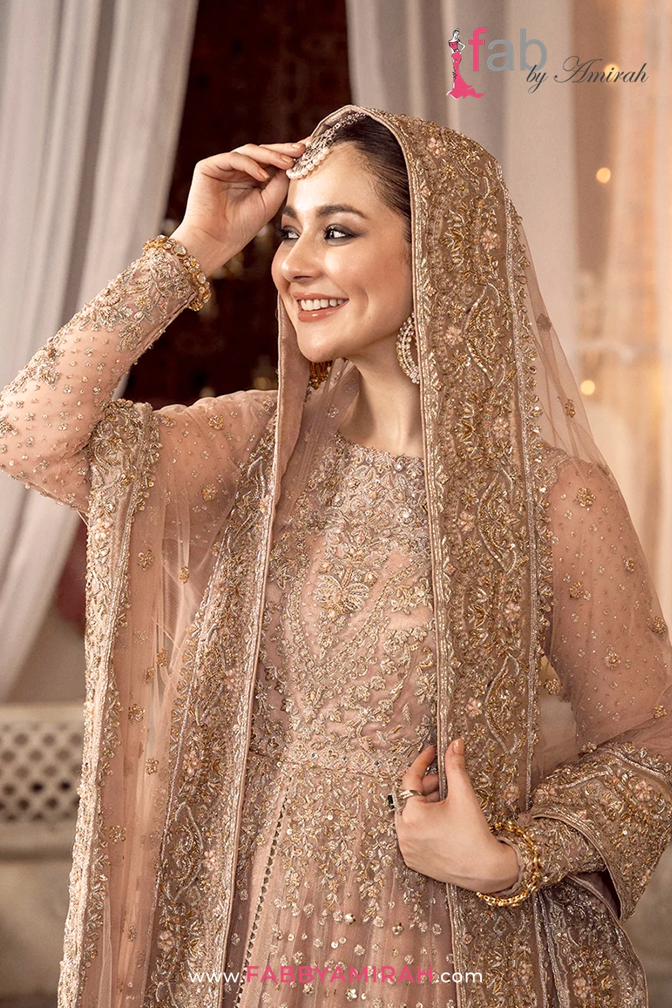 Close-up of handcrafted Tilla and Dabka embroidery on peach pink walima pishwas Close-up of handcrafted Tilla and Dabka embroidery on peach pink walima pishwas
