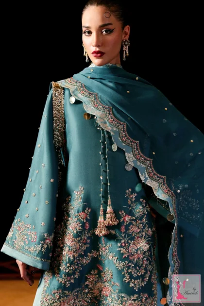 Close up of teal blue tunic neckline with hand embroidered tassel details