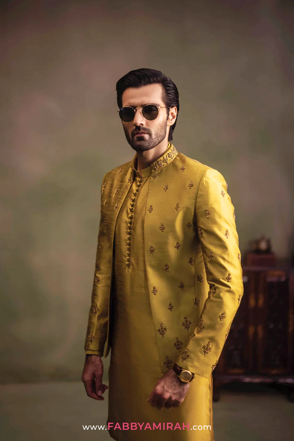 Close-up of handcrafted golden tilla work on mustard prince coat
