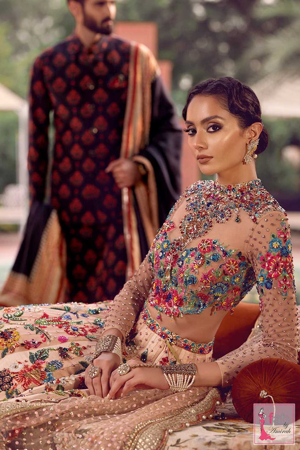 Seated pose highlighting jewel embellished neckline and hand harness