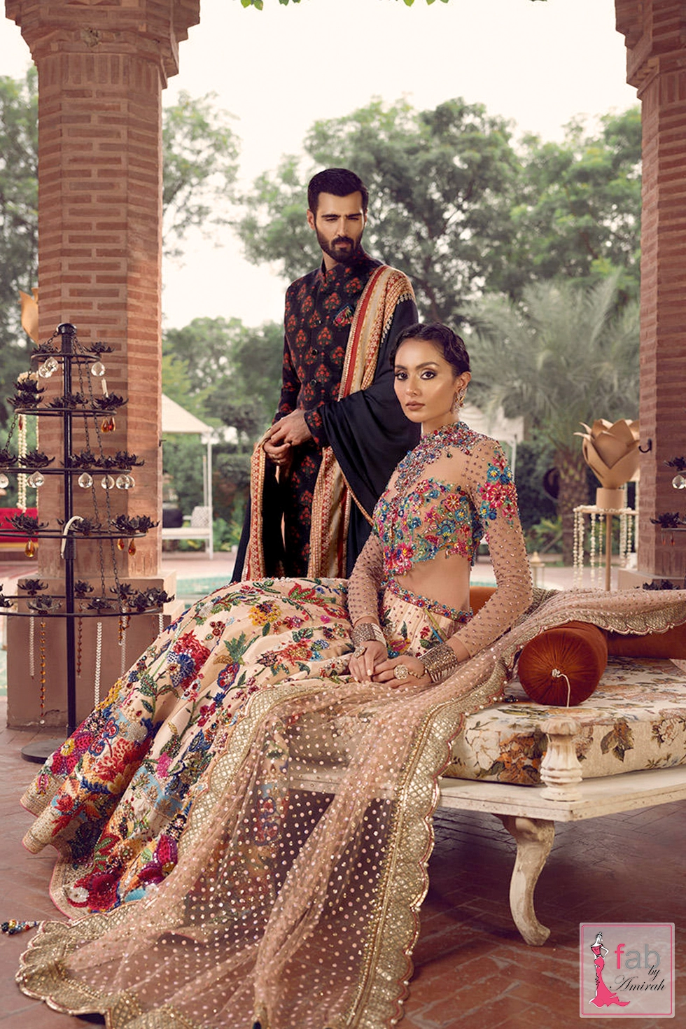 Full length view of peach lehenga sitting beside groom in sherwani