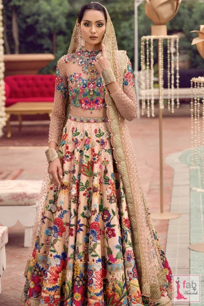 Peach embroidered lehnga dress with long sleeves and colorful floral hand embroidery