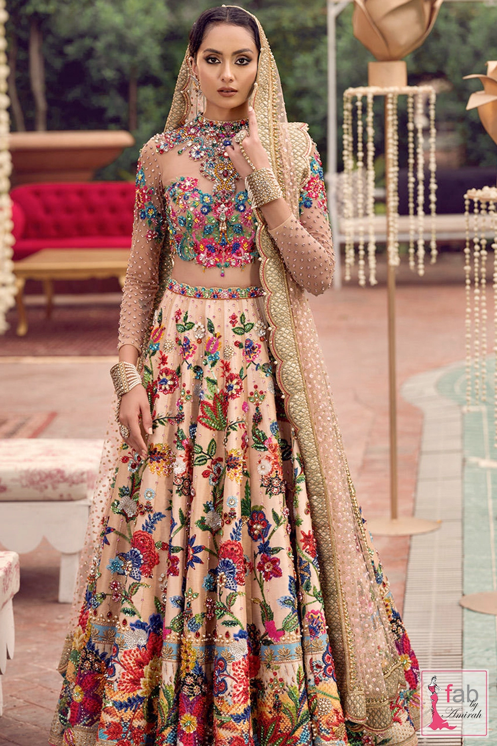 Peach embroidered lehnga dress with long sleeves and colorful floral hand embroidery