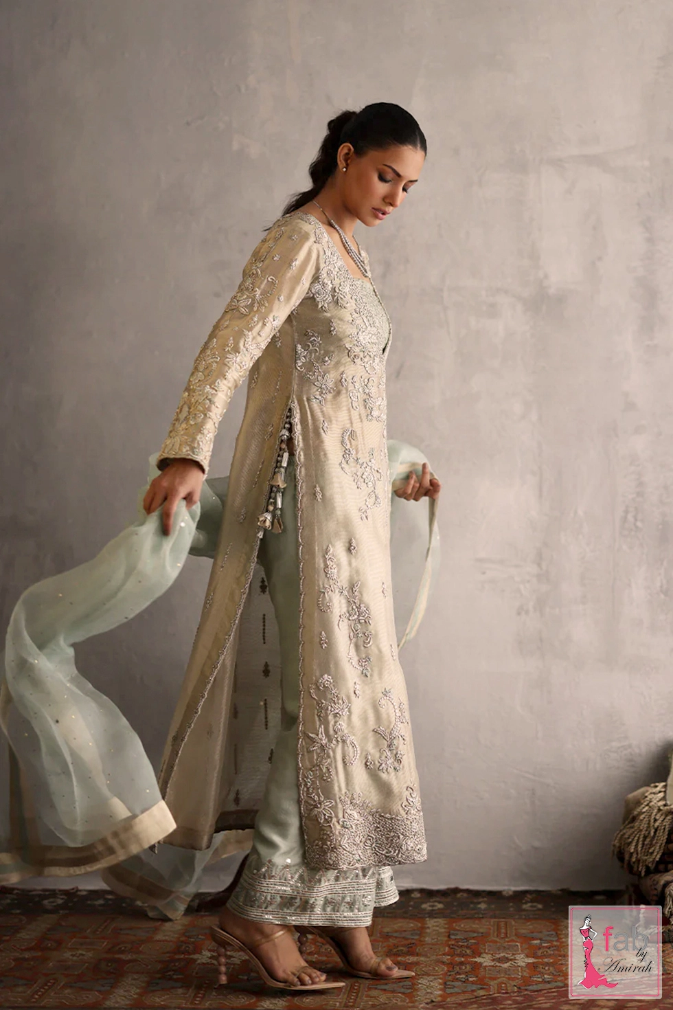 Angled shot of raw silk culottes with intricate turquoise threadwork borders
