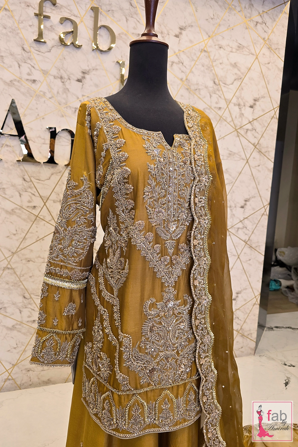 Angled shot highlighting hand worked long sleeves and scallop dupatta edge