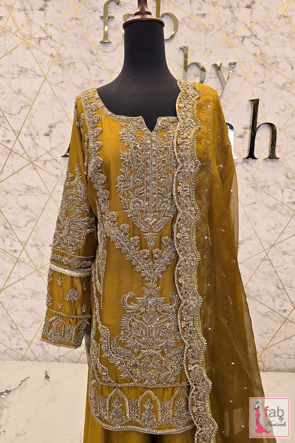 Medium shot showing hand embroidered neckline and sheer organza dupatta border