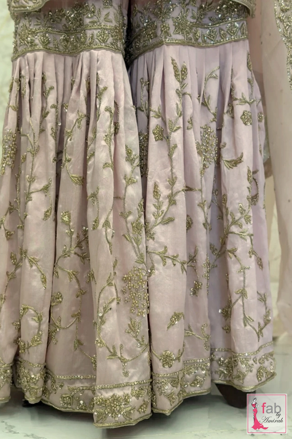 Close up of pleated gharara panels with delicate floral embroidery