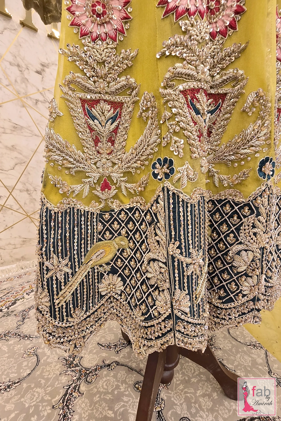 Detailed close up of navy blue embroidered border with peacock motif Detailed close up of navy blue embroidered border with peacock motif