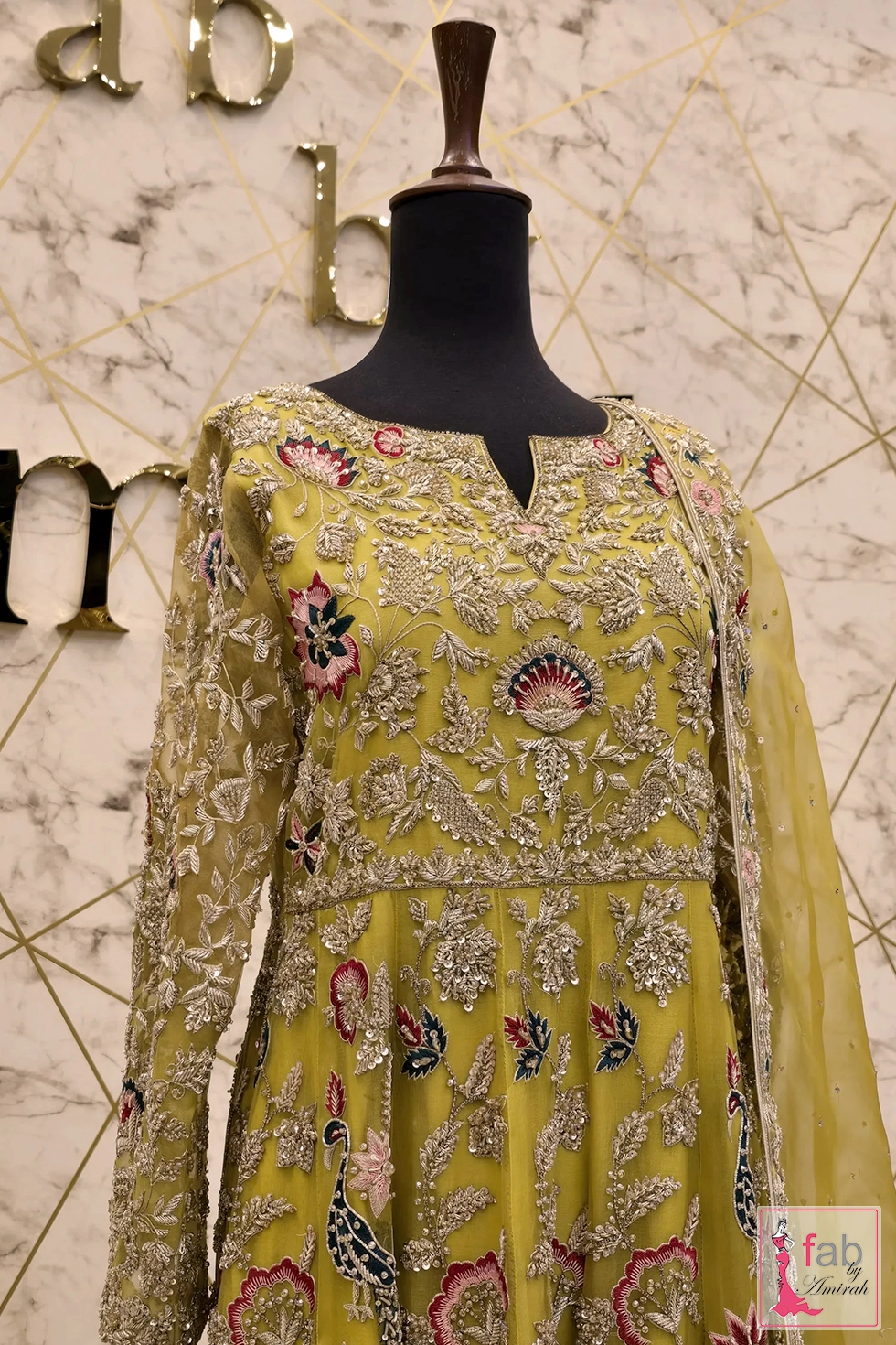 Upper bodice and sleeve embroidery close up on yellow net fabric Upper bodice and sleeve embroidery close up on yellow net fabric