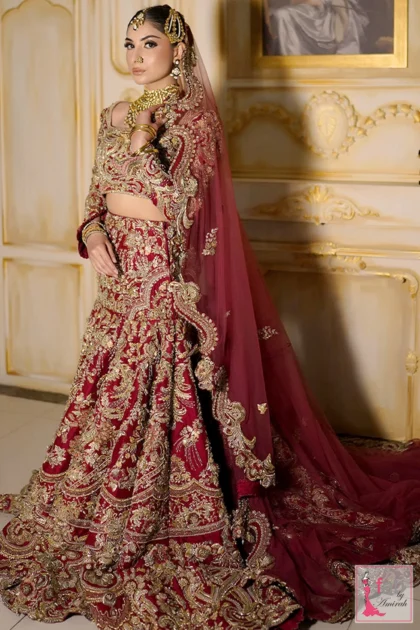 Side profile of bridal lehenga skirt showing rich gold handwork and deep red net dupatta