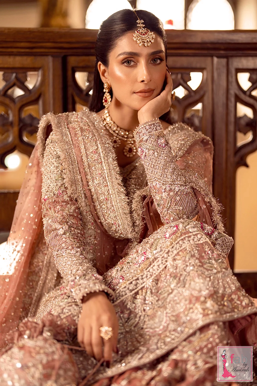 Seated portrait view showing hand worked sleeves and bridal dupatta border Seated portrait view showing hand worked sleeves and bridal dupatta border
