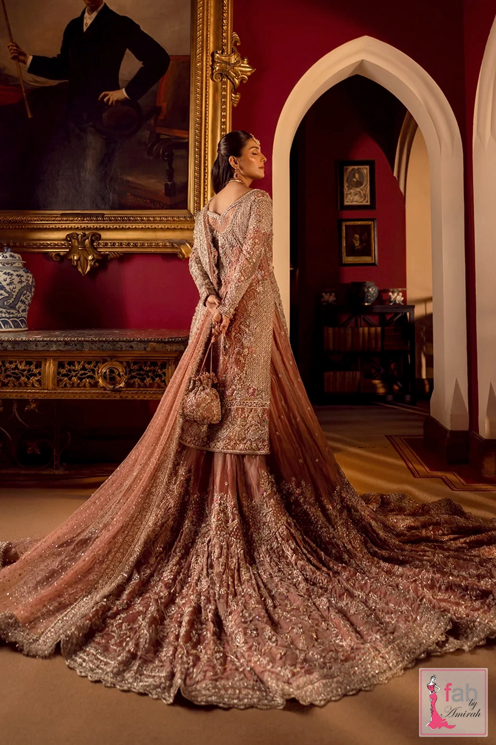 Back side angle showing long embellished shirt and trailing hemline Back side angle showing long embellished shirt and trailing hemline