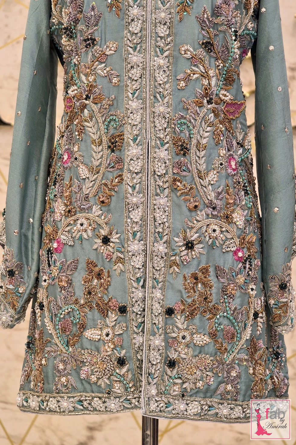 Mid length detailed view showing heavy hand embroidery and embellished front slit