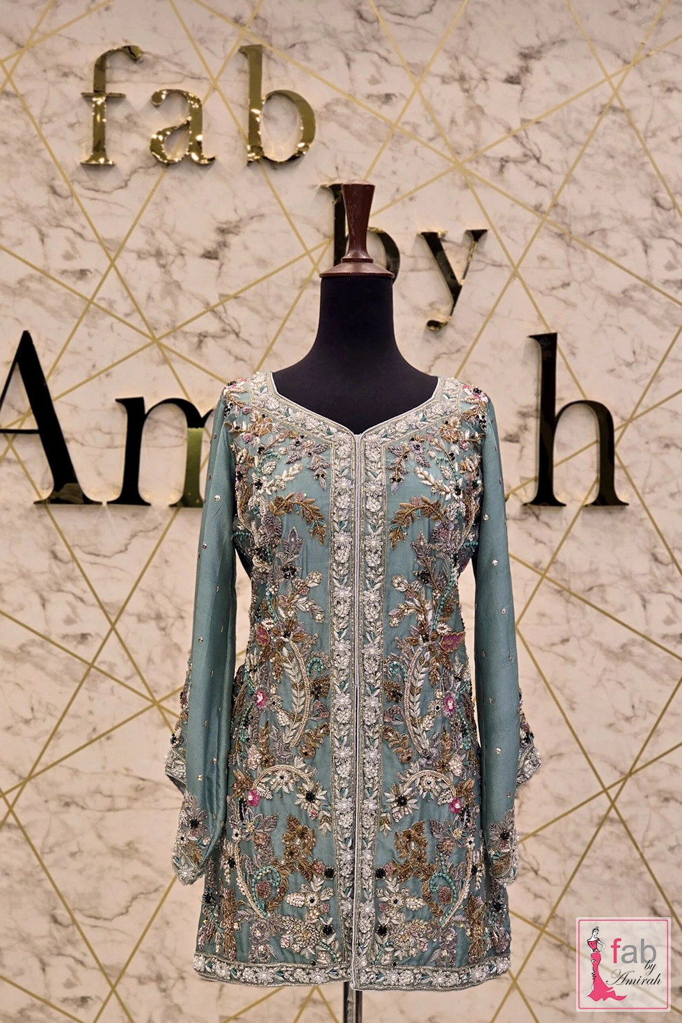 Hand embroidered sky blue embroidered kurti styled elegantly on a mannequin