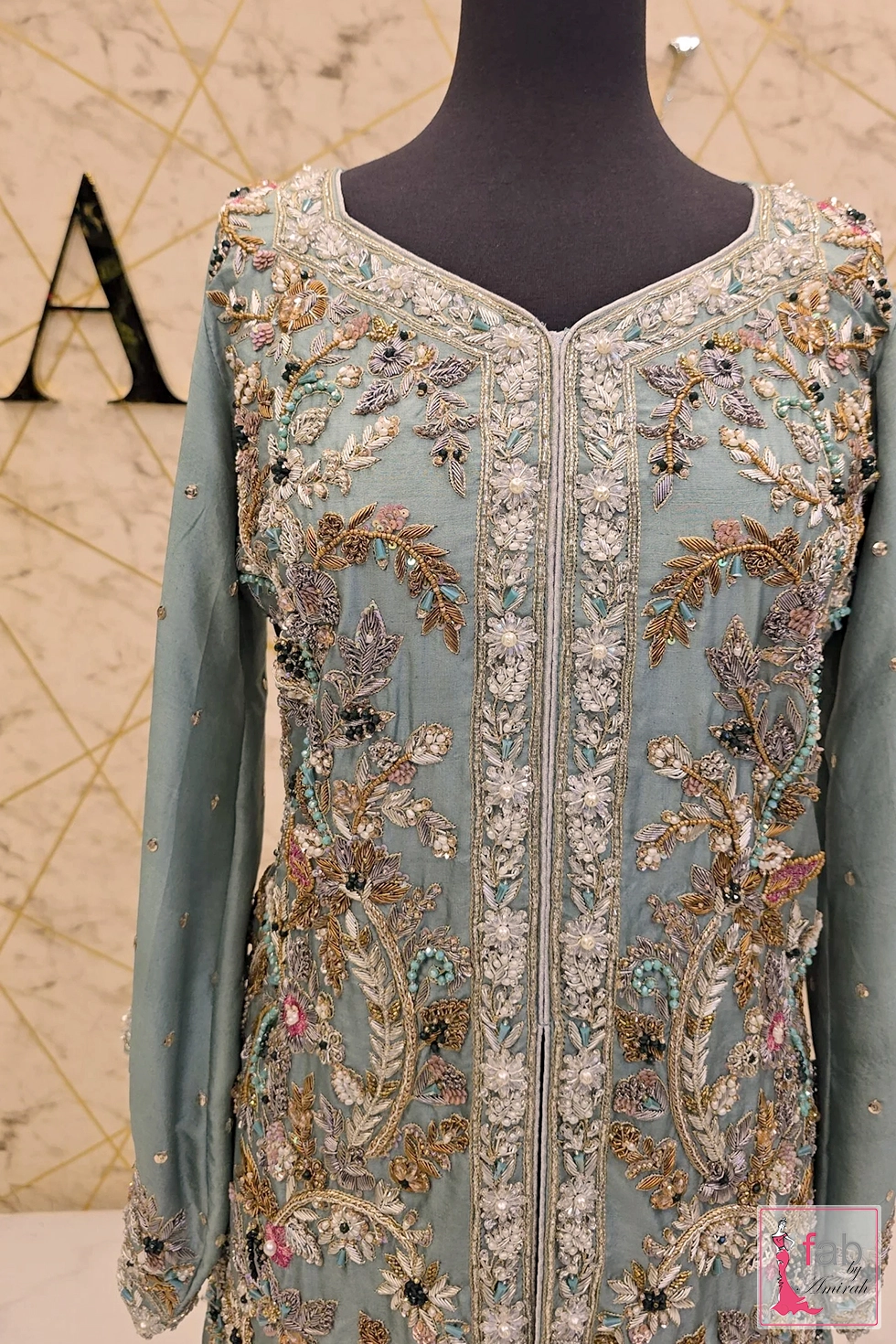 Close up of intricate floral zardozi embellishments around V neckline
