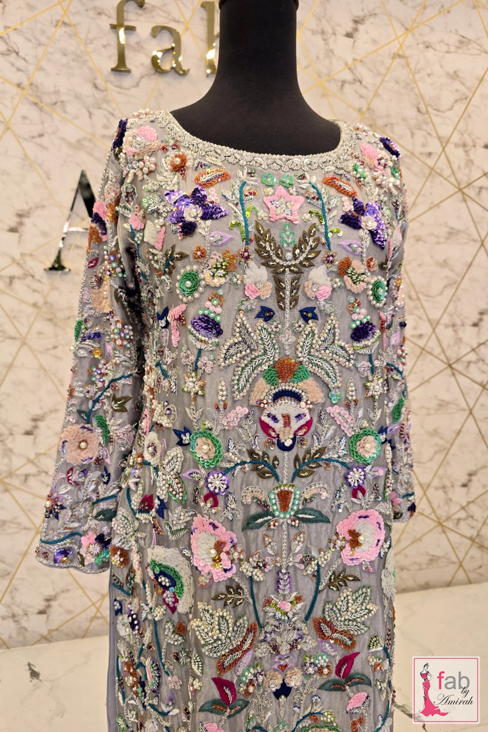 Close up detail of multi color embroidery and sequin work on front shirt
