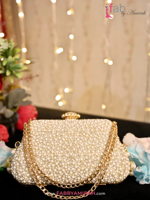 Matching the Sparkle: How to Pair Luxury Clutches with Your Bridal Look 3 Ivory pearl bridal clutch with gold ring clasp and chain - Fab by Amirah