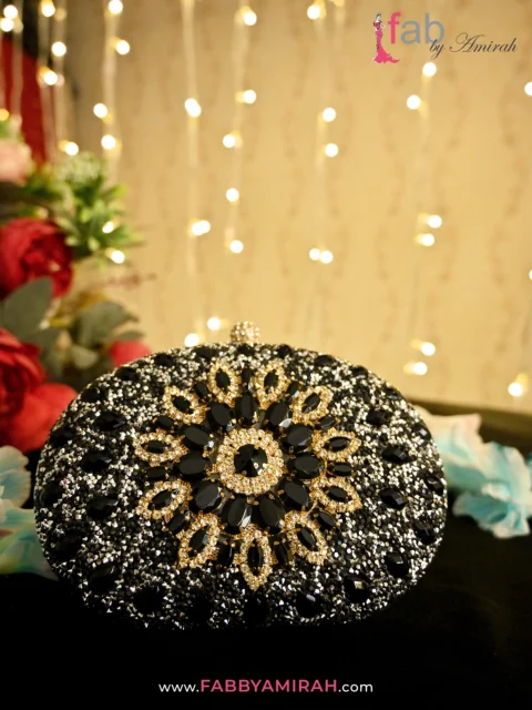 Matching the Sparkle: How to Pair Luxury Clutches with Your Bridal Look 5 Close-up of black teardrop stones and gold crystals on luxury bridal bag