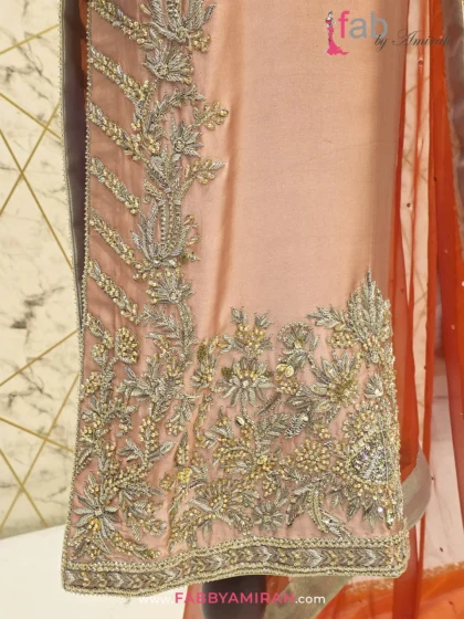 Close-up of handcrafted Zardozi and Dabka work on peach long shirt