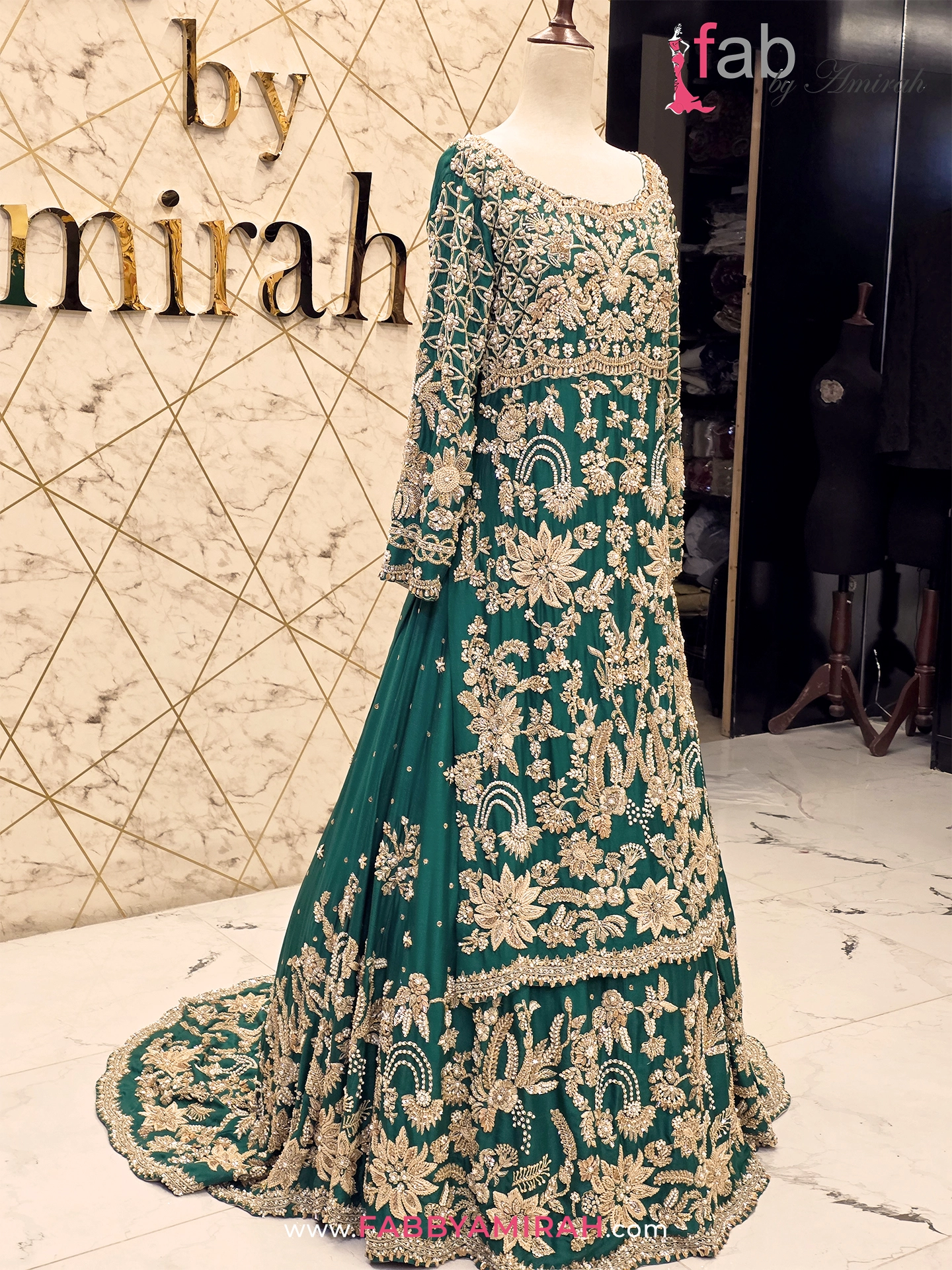 Close-up of handcrafted Mughal zardozi work on green bridal lehenga with long shirt Close-up of handcrafted Mughal zardozi work on green bridal lehenga with long shirt