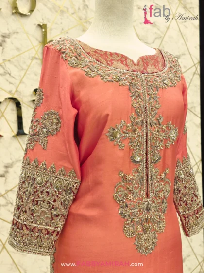 Close-up of handcrafted Dabka and Zardozi on peach organza suit shirt