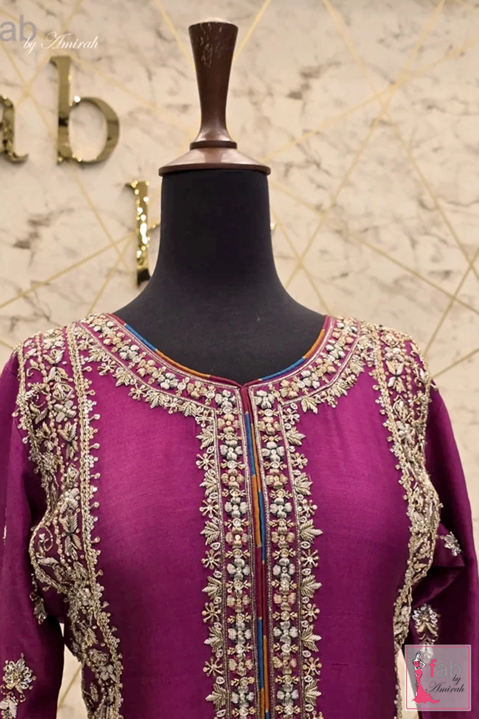 Close up of hand embroidered split neckline with intricate beadwork and contrast piping Close up of hand embroidered split neckline with intricate beadwork and contrast piping