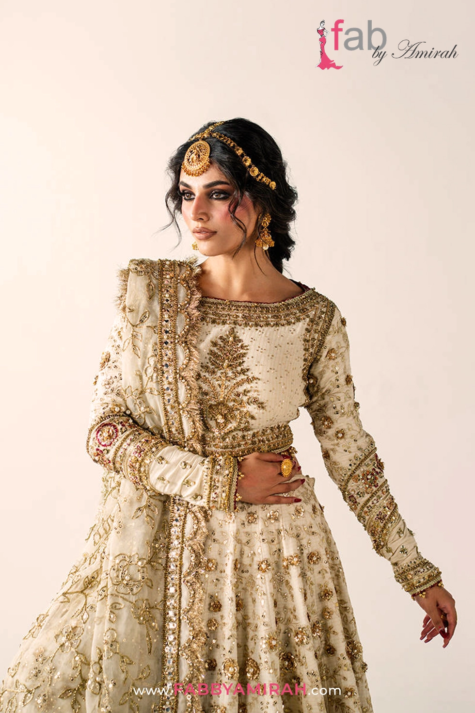 Majestic off white gold bridal lehenga styled for a traditional Pakistani wedding ceremony