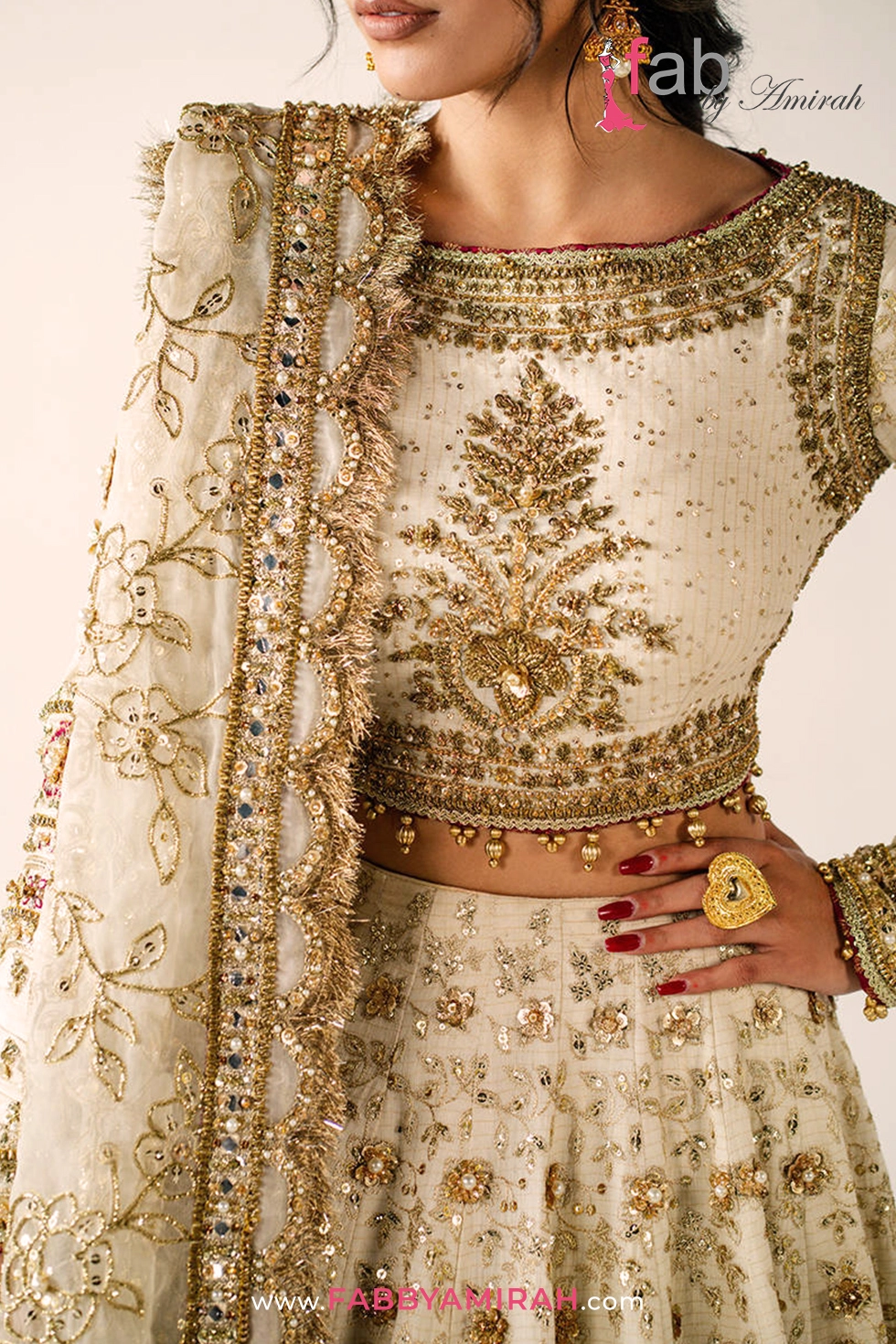 Close-up of pita and naqshi work on off white gold bridal lehenga ensemble