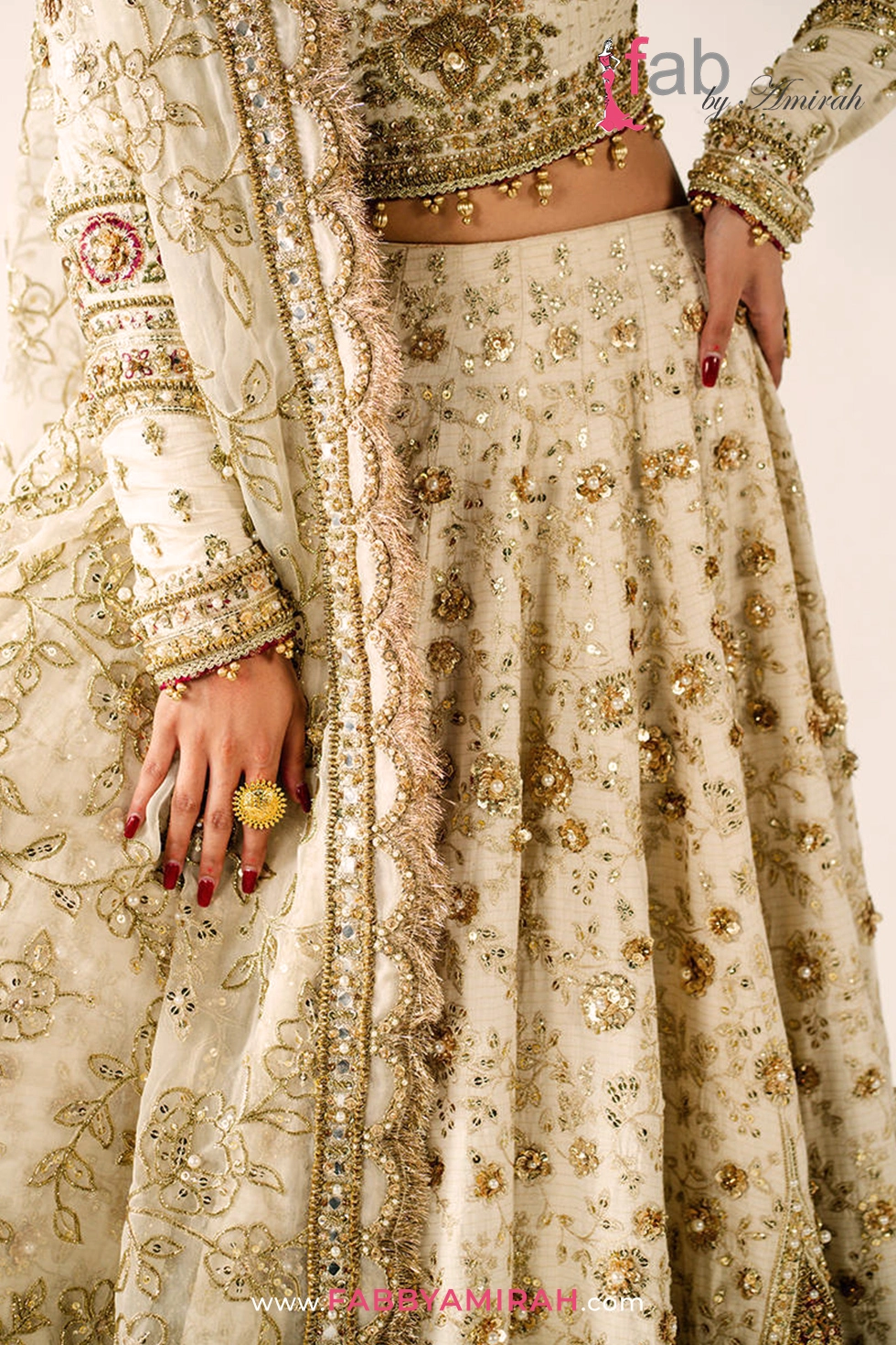 Close-up of pita and naqshi work on off white gold bridal lehenga ensemble