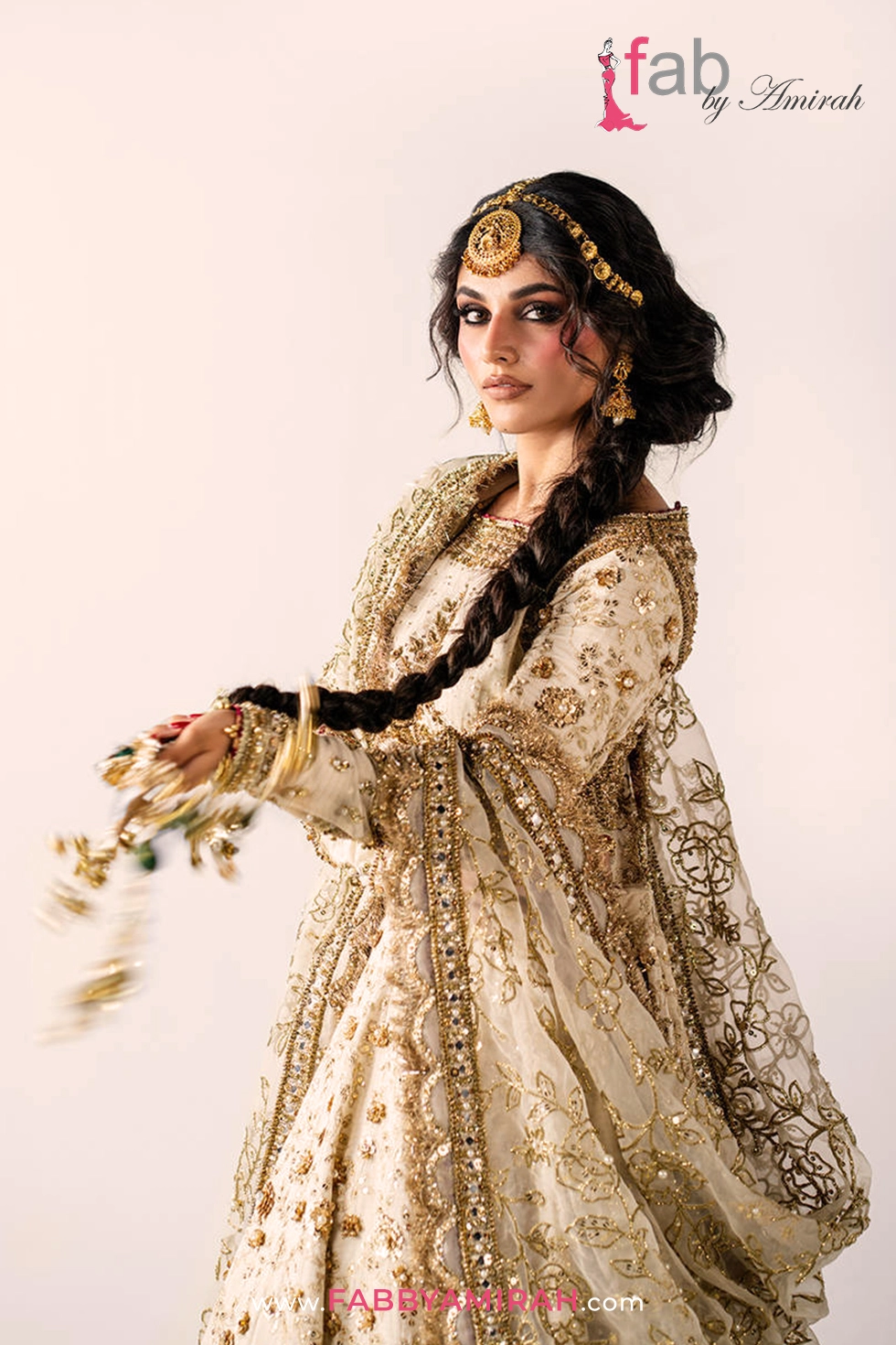 Majestic off white gold bridal lehenga styled for a traditional Pakistani wedding ceremony