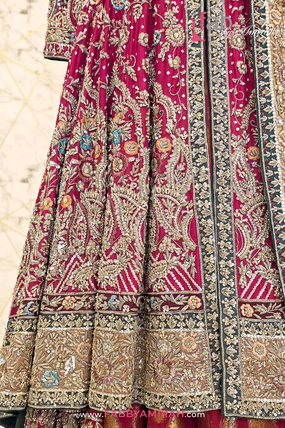 Close-up of handcrafted zardozi embroidery on patterned jamawar skirt