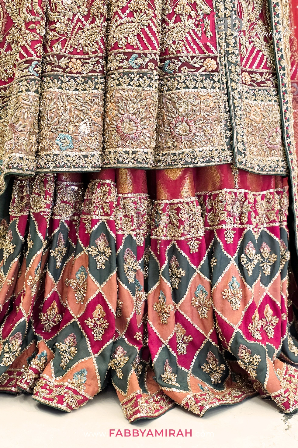 Close-up of handcrafted zardozi embroidery on patterned jamawar skirt