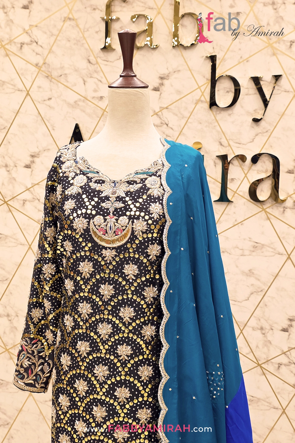 Heavy gold thread work on traditional black formal wear