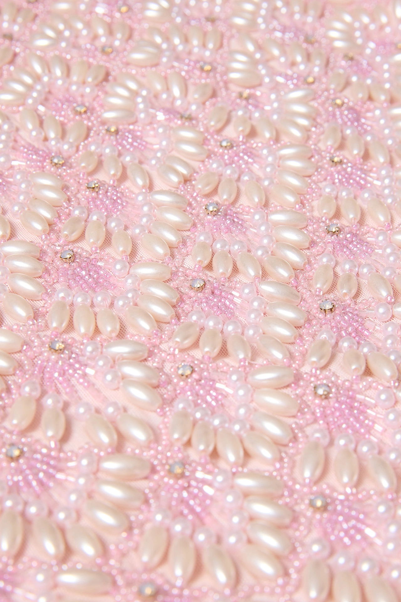 Close-up of short pink dress for party showing model and matching beaded pink bag