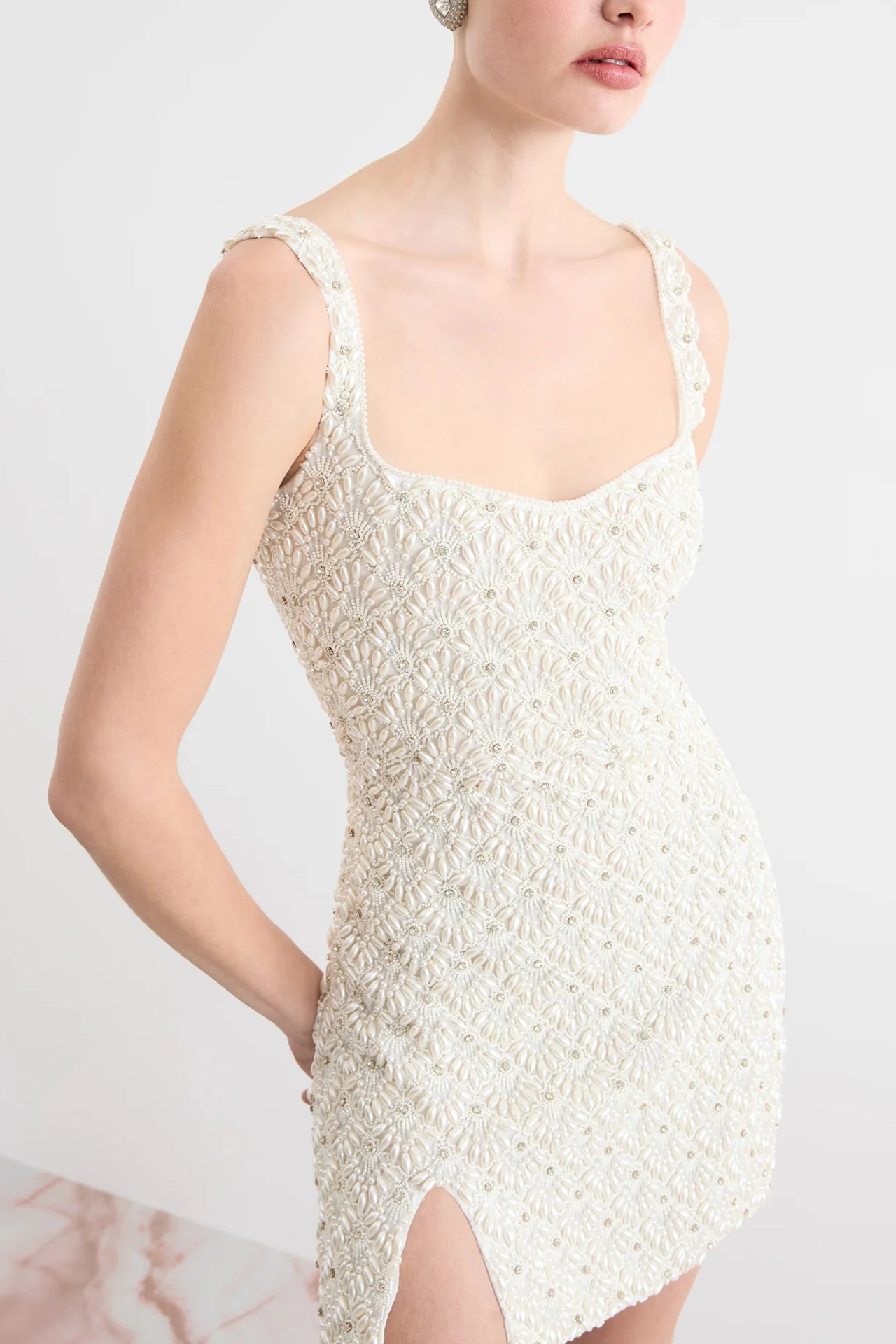 Clean low square back view of ivory romantic bridal mini dress with thick straps