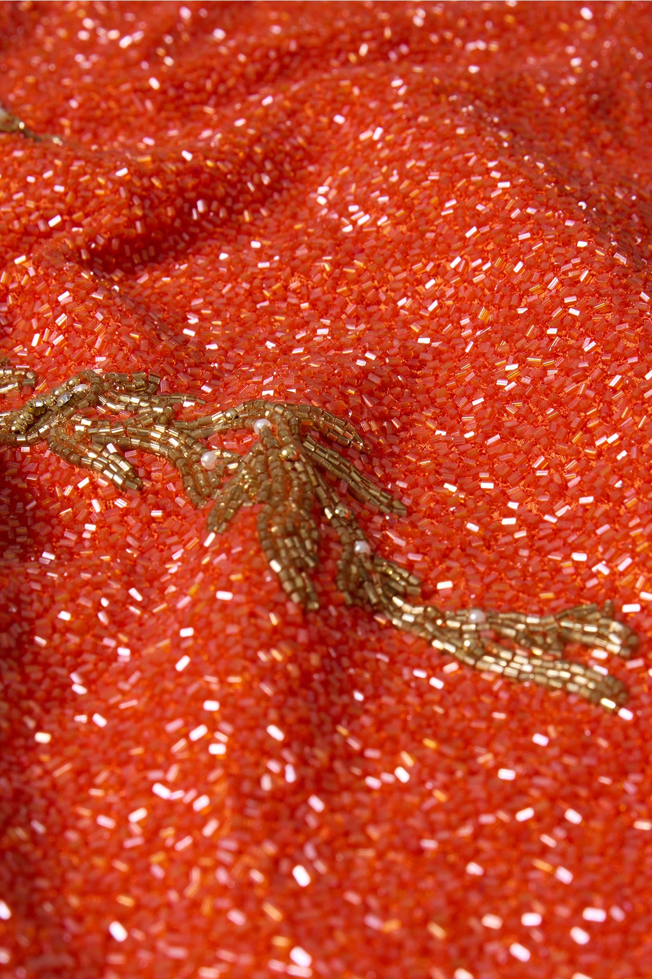 Close-up of rose pink mini dress showing model holding a matching beaded pink bag