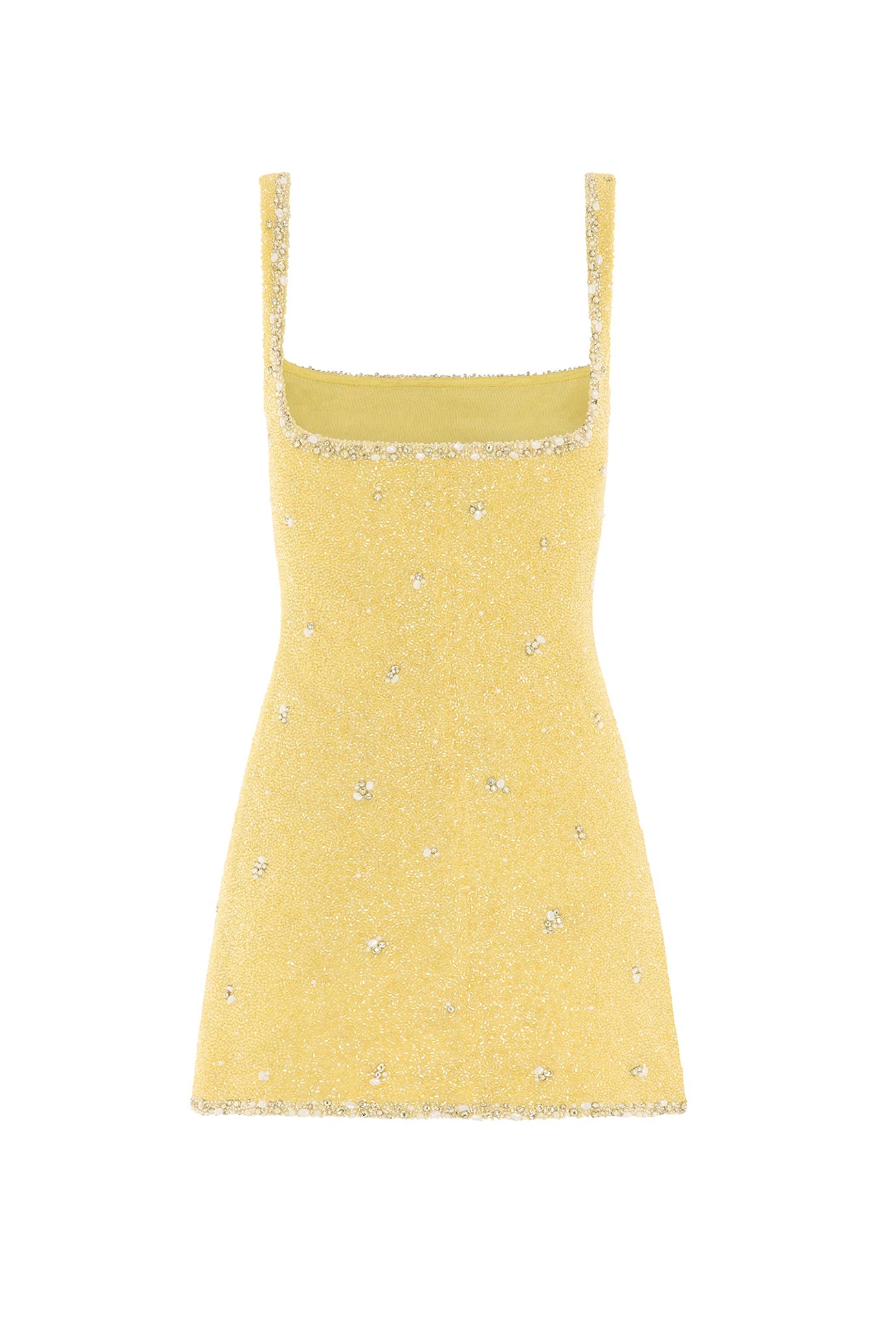 Close-up of model wearing yellow dress with crystals showing hand-placed beads